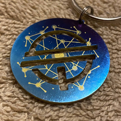 Quantum Stellar Initiative | Titanium Cut Through Keychain